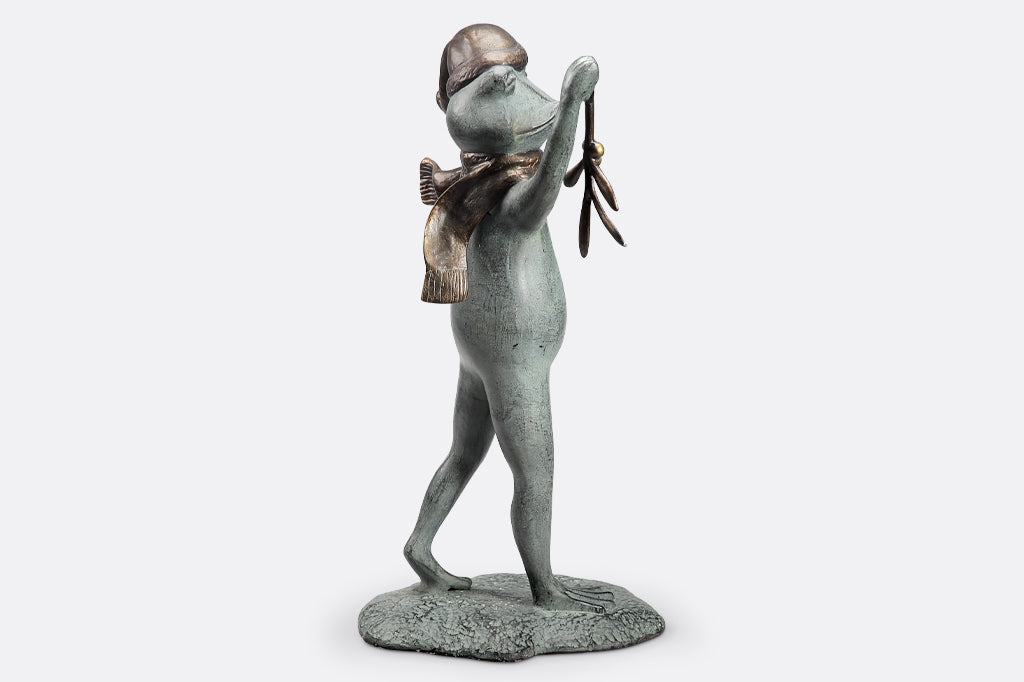 garden sculpture of frog in winter garb holding mistletoe from outstretched webbed hand
