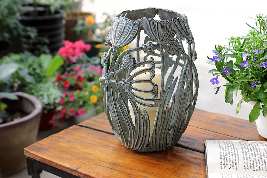 Garden Party Candleholder shown on outdoor table with book and flowerpot