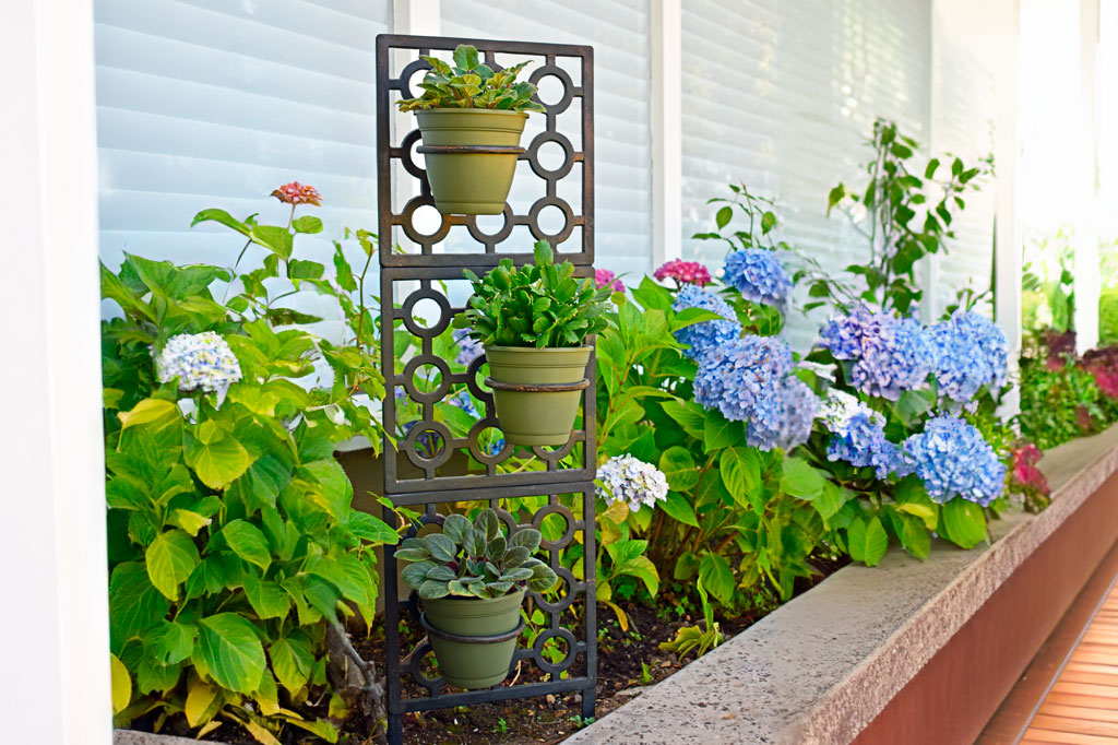 modular trellis with planter rings shown in hydrangea garden