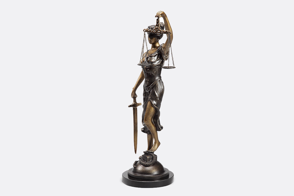Classic office sculpture of lady justice, complete with scales and sword