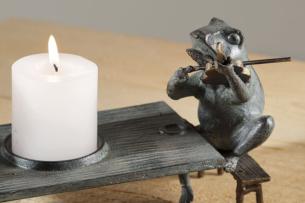 close up view of frog sculpture playing violin