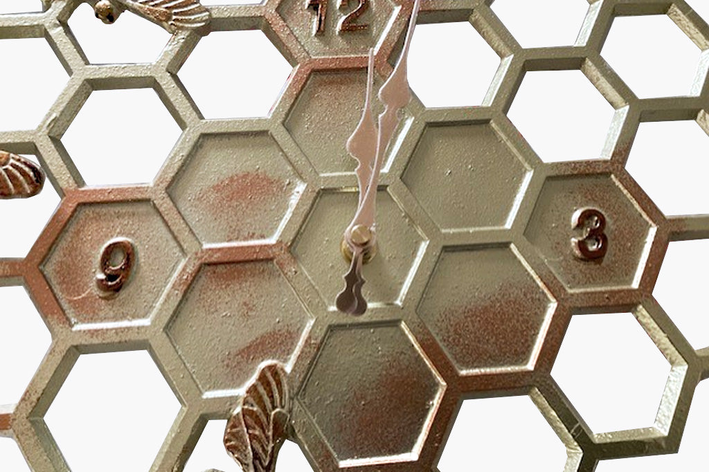 closeup of the gold and rust finish accents on the clock