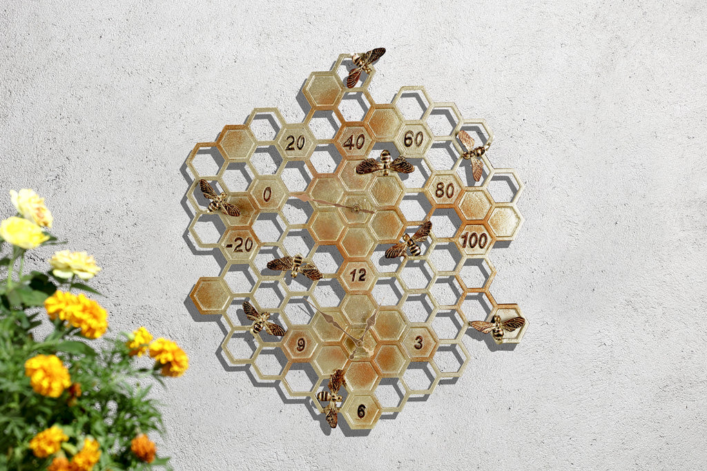 Wall clock and thermometer for outdoor or indoor. Shown on honeycomb pattern hexagon with accent sculpted bees, all in golden finish with pinky red accents