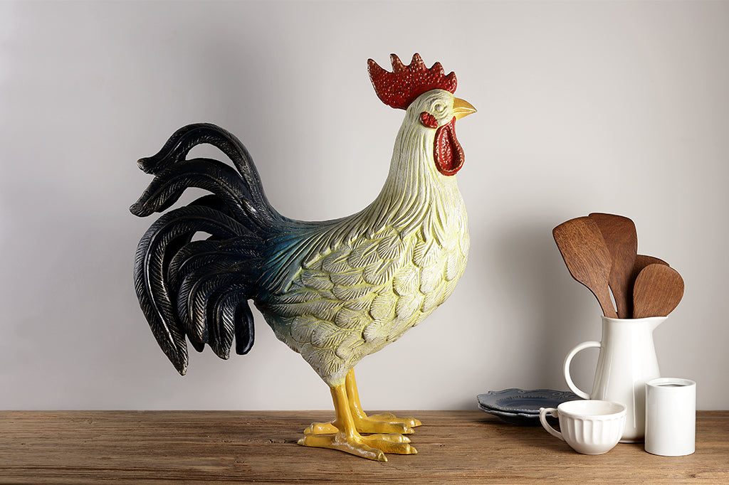 large and colorful cast metal rooster sculpture home decor, shown on wood kitchen counter with ceramic tableware