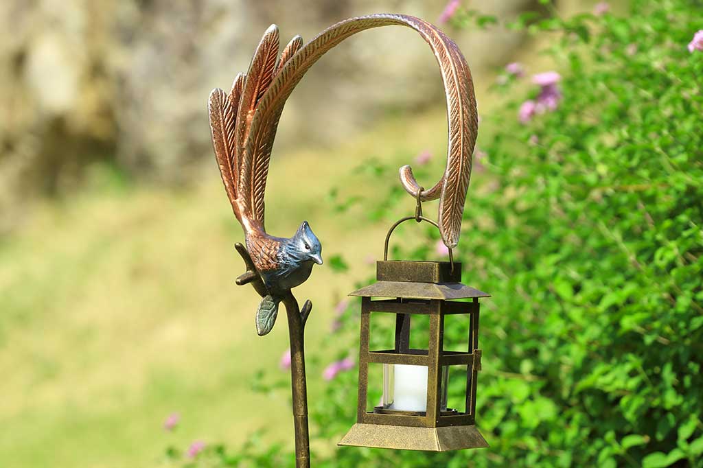 Flycatcher outdoor staked lantern with votive candle staged in garden background