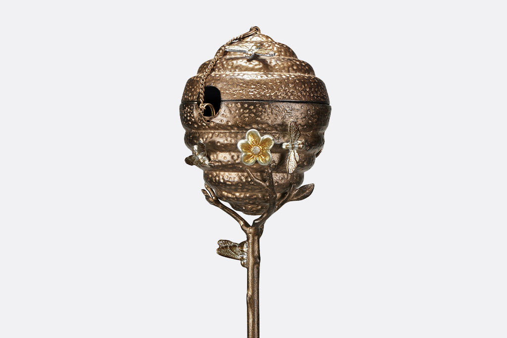 Metal Beehive oil torch with cap on, flower and small bee details