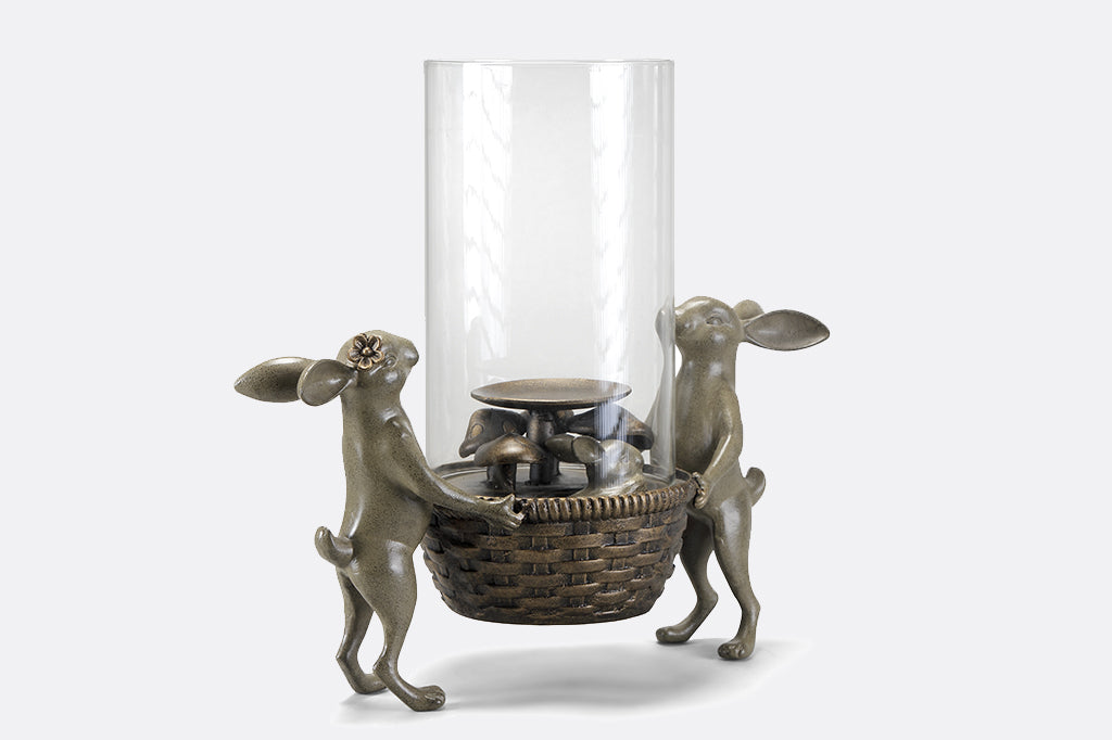 bunny candle holder shows two bunnies holding a basket and tall glass candle shield