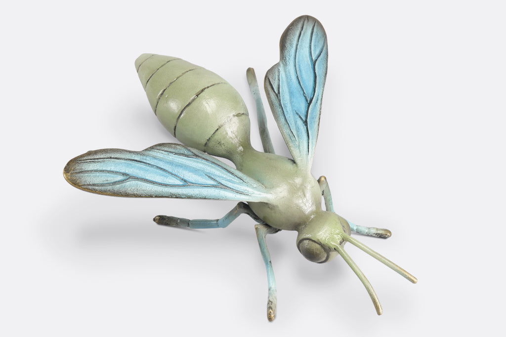 Sculpted metal wasp in soft shades of blue and sage green, top view