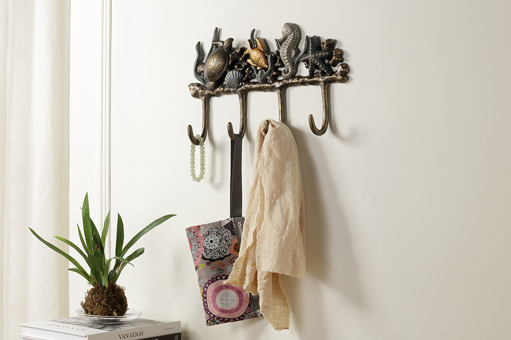 Metal wall hook featuring sea turtle, fish, seahorse, and starfish staged on wall