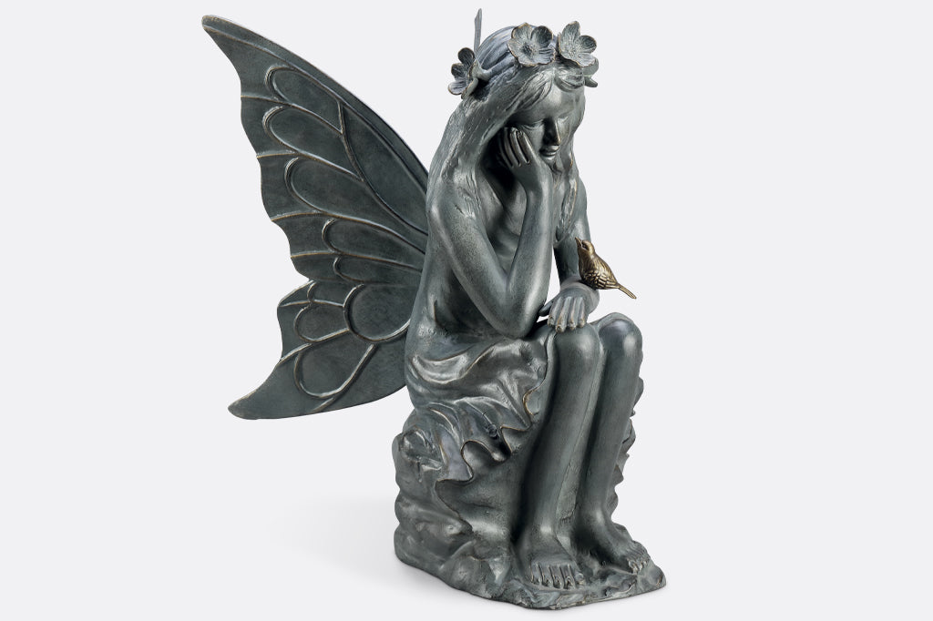 fairy garden sculpture face right to show off swirls of fairy wings and ripples of dress