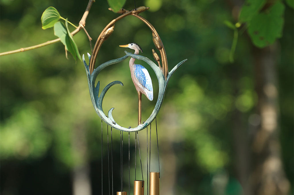 close up view of cast metal heron wind chime