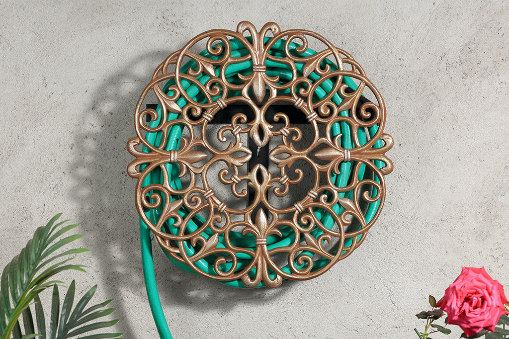 Metal rose gold tinted hose holder staged on outdoor wall