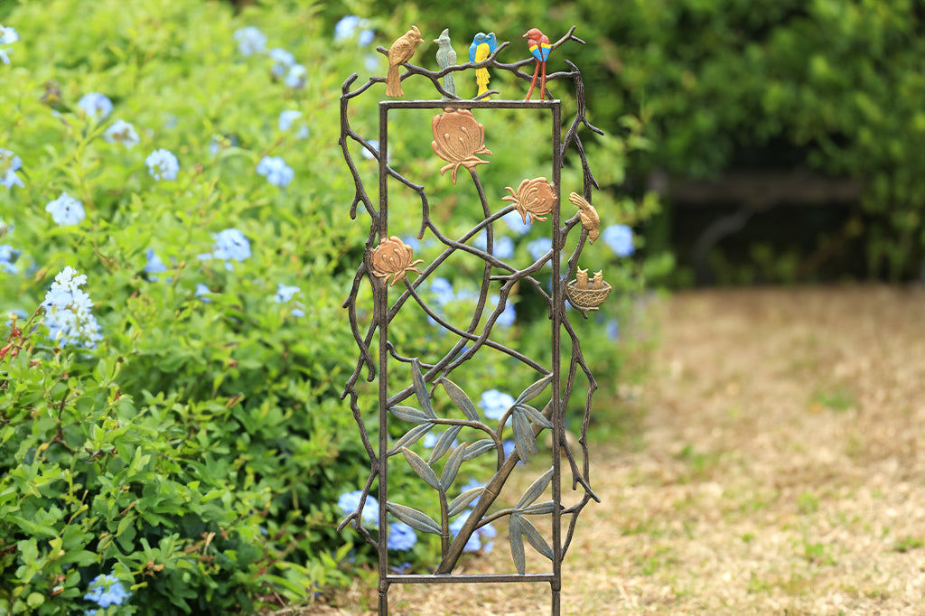 Metal garden trellis featuring quartet of birds, clovers and thistle motifs