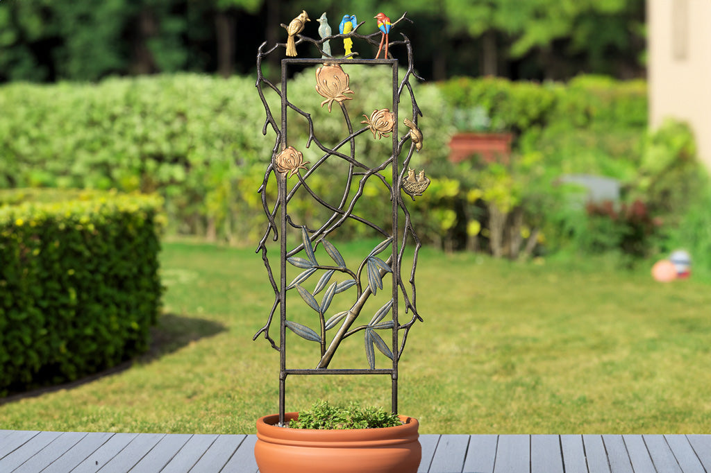 Birdsong and Blooms trellis in a large planter pot on a deck with view of garden