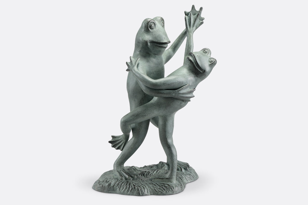 cast metal dancing frog sculpture one frog tipping the other over in a tango