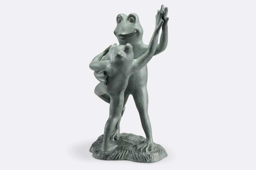 cast metal dancing frog sculpture one frog tipping the other over in a tango
