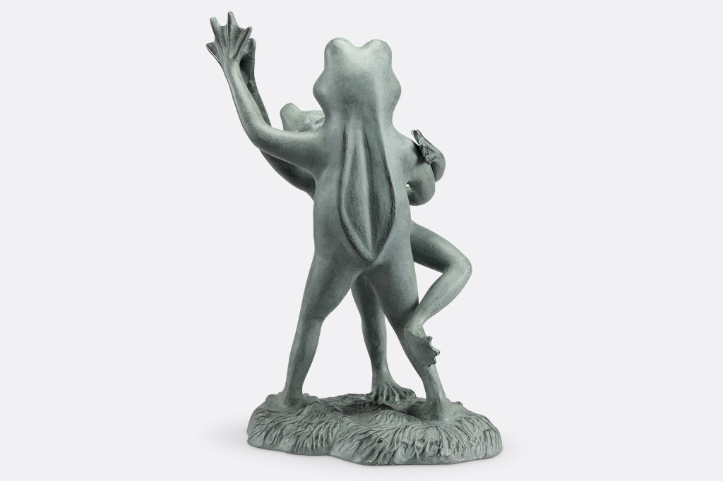 cast metal dancing frog sculpture one frog tipping the other over in a tango