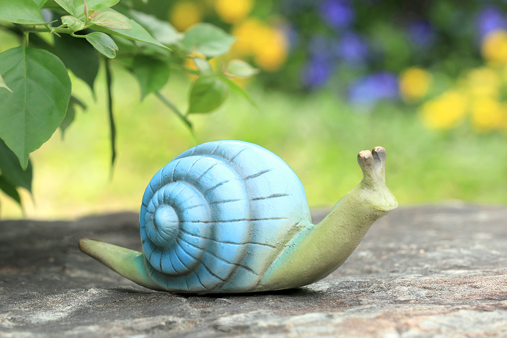 light blue snail cast metal garden sculpture set on rock