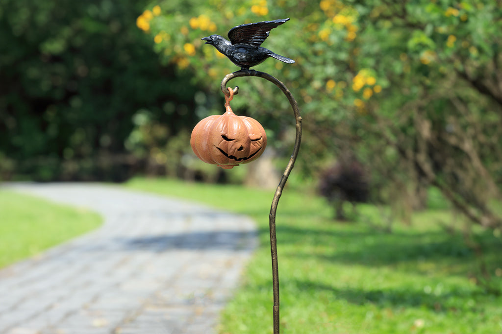 metal staked lantern with hanging jack-o-lantern candleholder with black raven sat atop