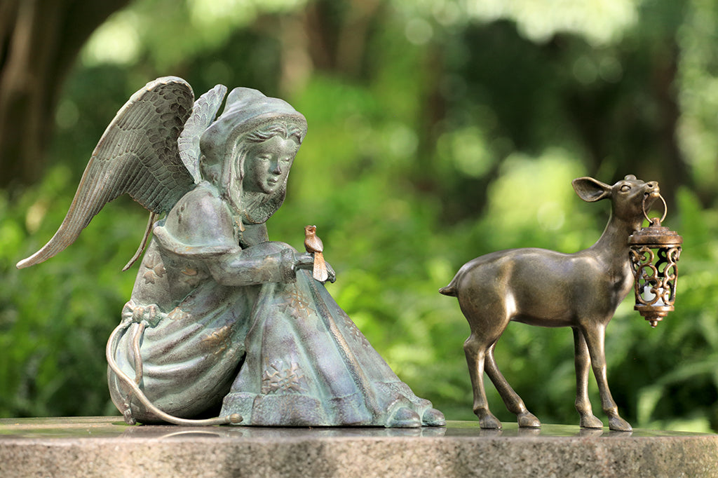Cast Metal winter angel with bird on hand, with deer holding a lantern