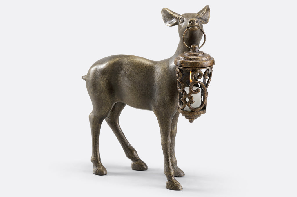 Cast Metal deer holding lantern in mouth with votive candle
