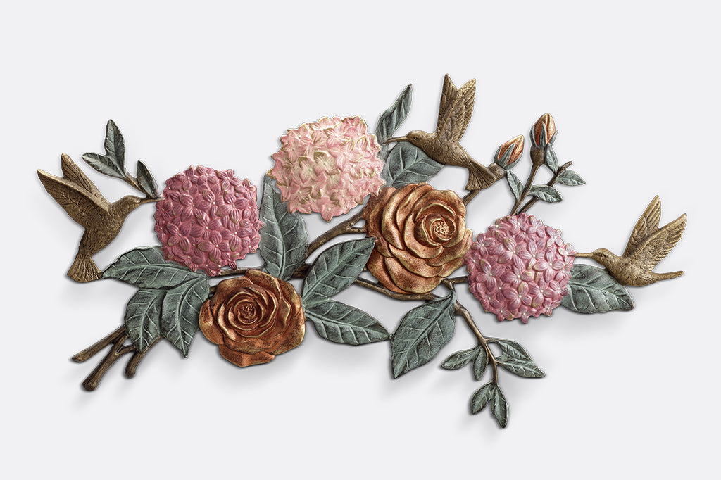 cast metal roses, hydrangeas and hummingbirds wall plaque. Fluttering hummingbirds arounds pink roses