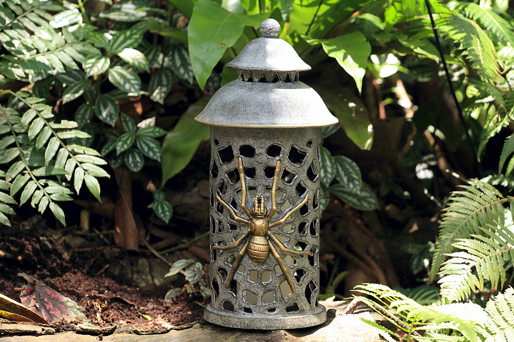 cast metal lantern with two spiders and webbing cut outs