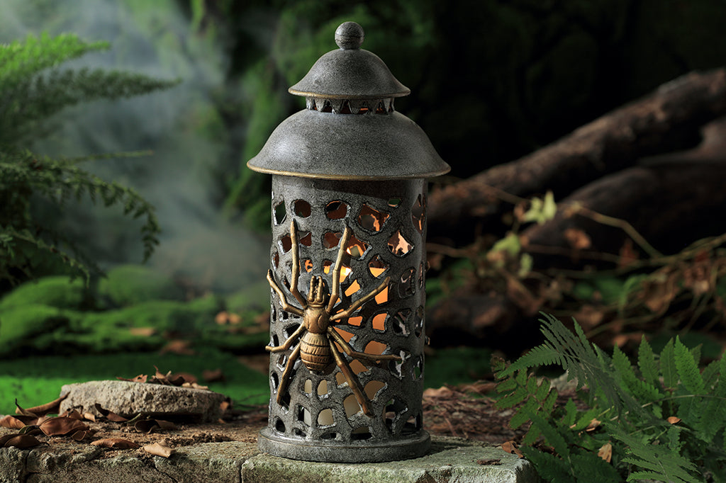 cast metal lantern with two spiders and webbing cut outs