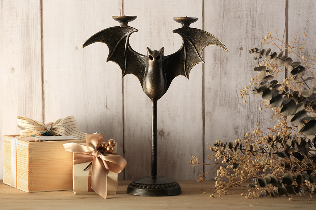Cast metal bat tapper candle holder