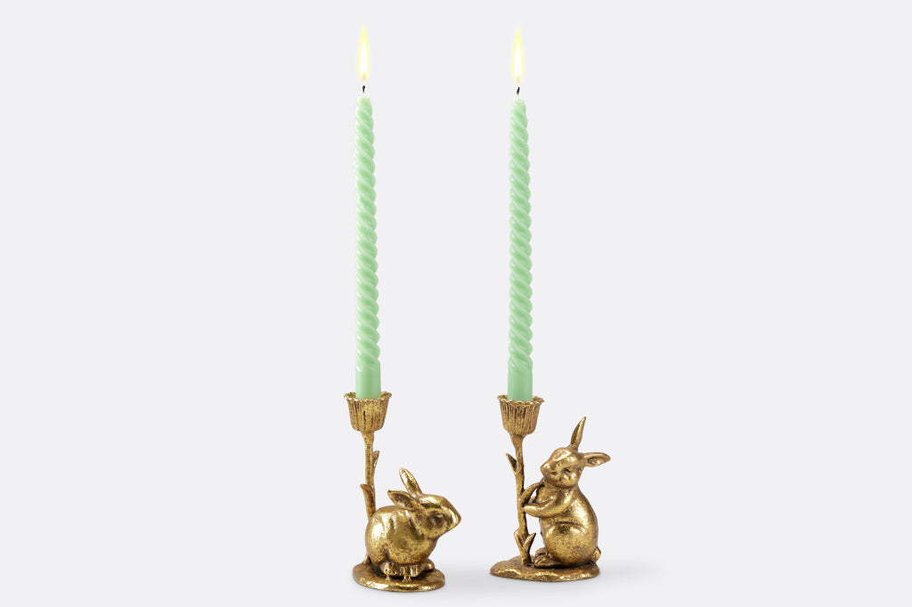 cast metal gold bunny candleholder duo, set of two. Staged with mint green twisted taper candles