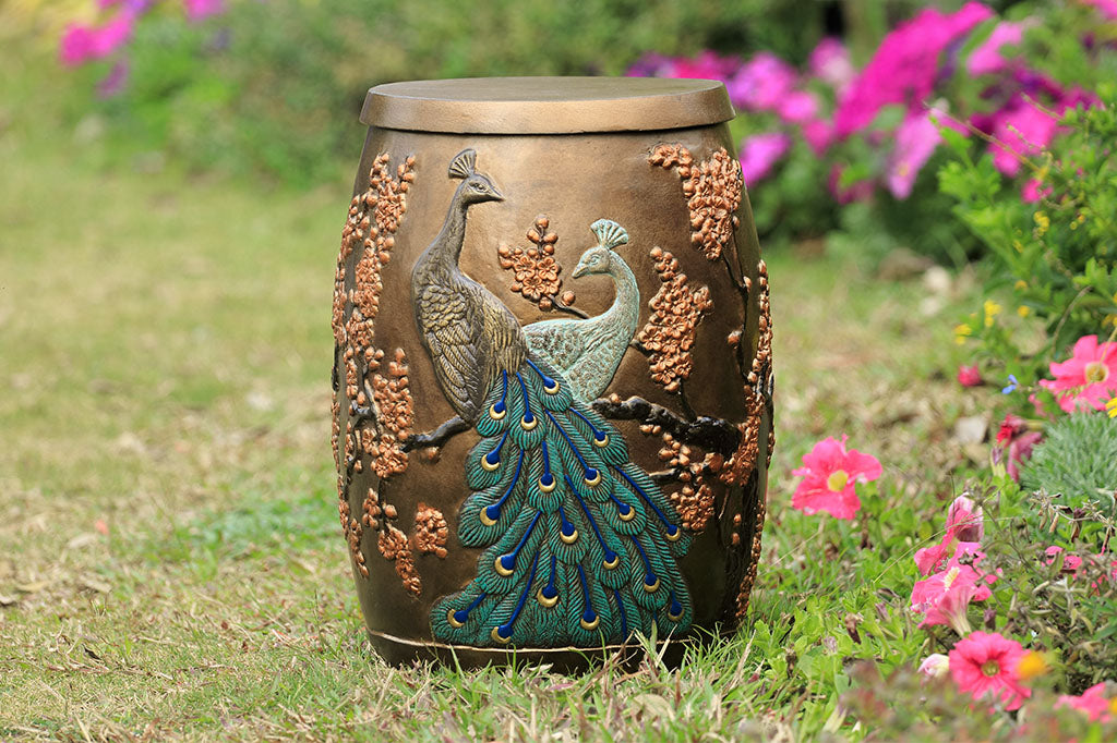 Cast Aluminum stool with storage space inside is shown in garden and features two peacocks entwined among flowering blossoms