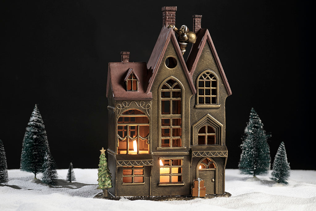 Up on the Rooftop Candle House candleholder with removeable santa, tree, and present accessories shown with holiday table scape using artificial snow