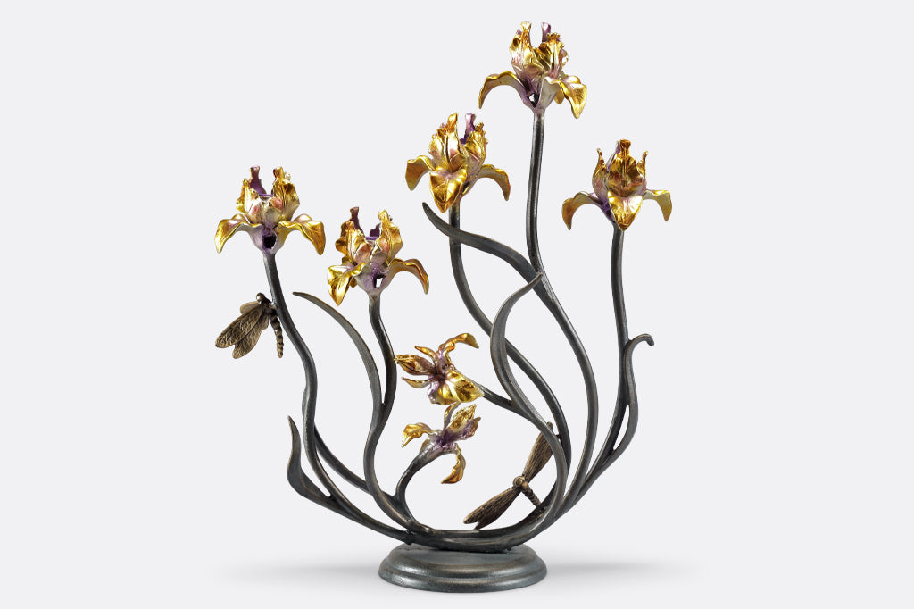 cast metal iris taper candelabra holding five tapers, irises are a delicate blend of yellow with purple. Dragonfly detailing on stem of flowers