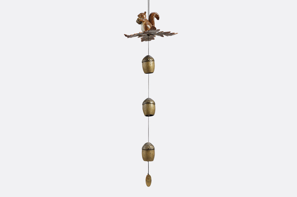 Decorative wind art with a squirrel and acorn design on a white background
