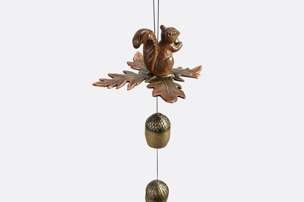 Decorative wind art with a squirrel and acorn design on a white background