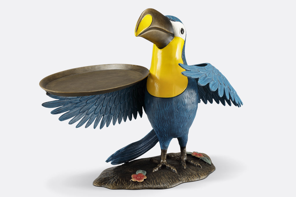 cast metal toucan holding a serving tray on wing, blue and yellow toucan face front