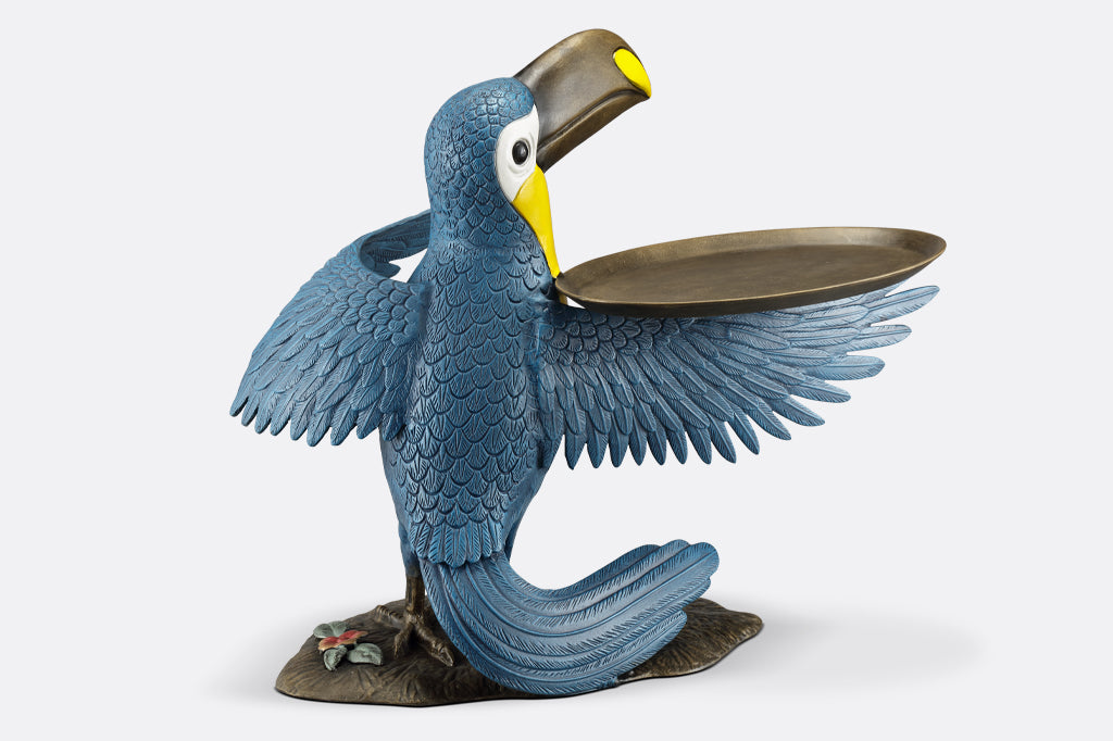 cast metal toucan holding a serving tray on wing, blue and yellow toucan face back