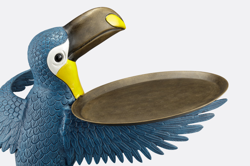 cast metal toucan holding a serving tray on wing, blue and yellow toucan detailed view