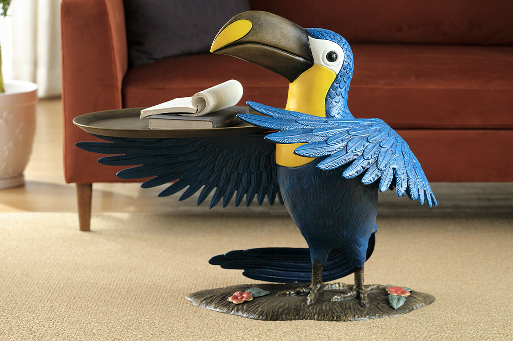 cast metal toucan holding a serving tray on wing, blue and yellow toucan