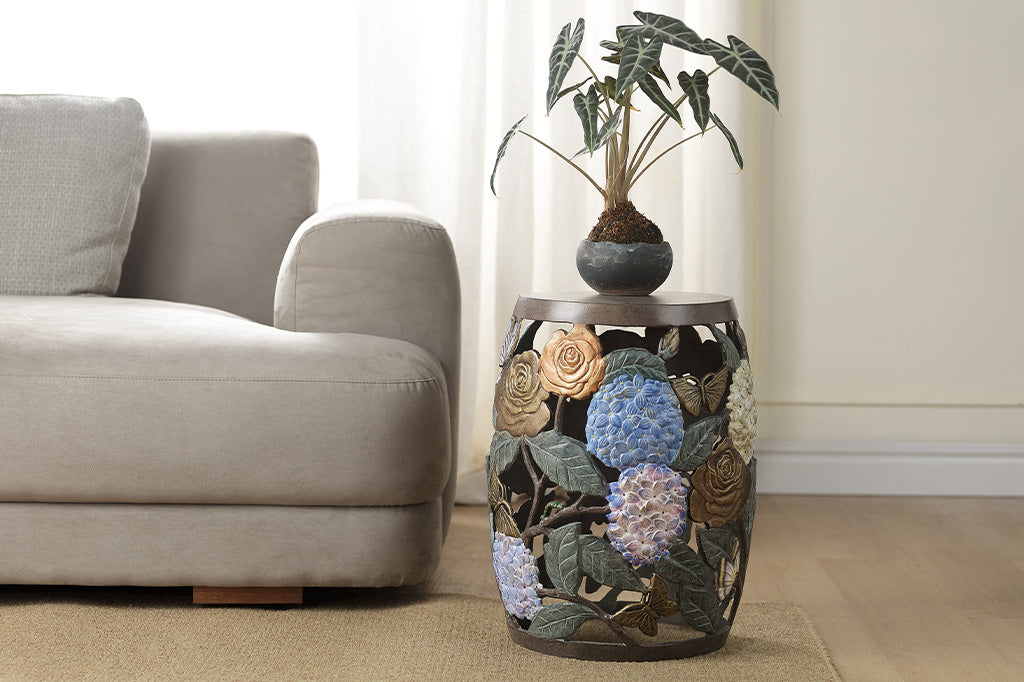 Cast metal garden stool features beautiful roses, butterflies, and the vibrant hues of hydrangeas.
Shown in living room
