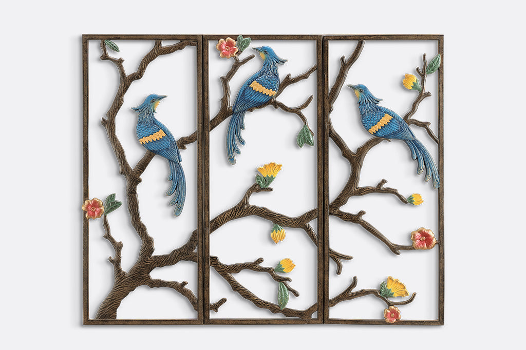 Decorative wall art with birds and branches on a white background