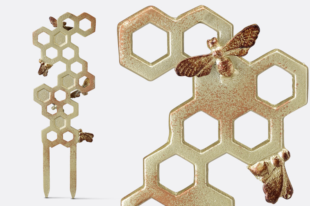 detail view of honeycomb design and bees of planter trellis