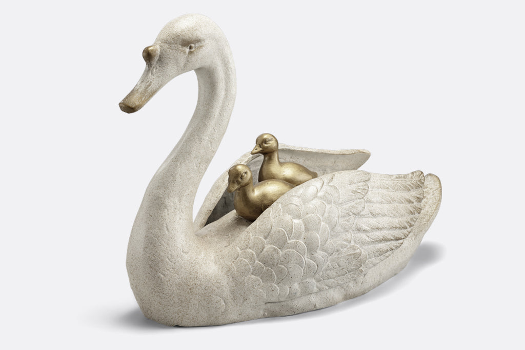 cast metal garden sculpture of mama swan with two baby cygnets nestled on her back