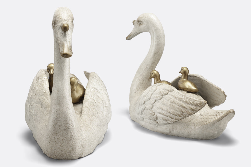 cast metal garden sculpture of mama swan with two baby cygnets nestled on her back