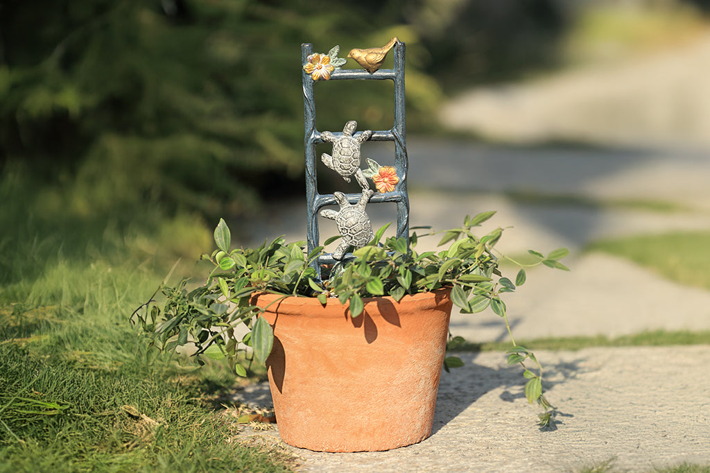 cast aluminum pot trellis featuring two turtles climbing on a flower vine ladder in pot