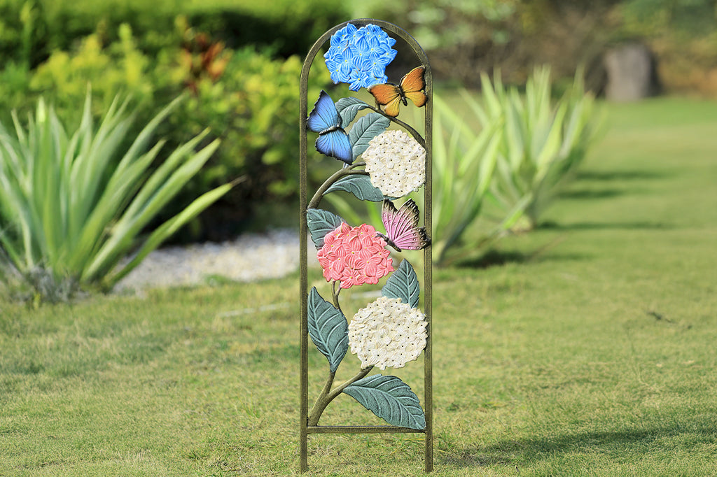 multi-color hydrangea and butterfly garden trellis set in garden bed