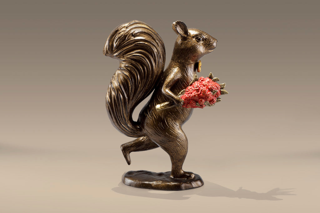 Garden sculpture of squirrel wearing bowtie, running with bouquet of red roses in its paw.