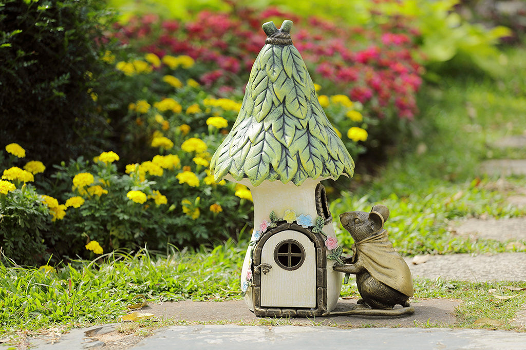 Garden candle lantern shaped like mouse and cottage - shown outside n garden path