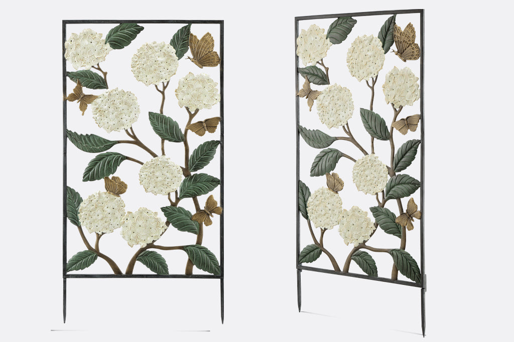 white hydrangea with fluttering butterfly garden trellis