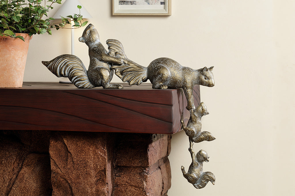 A sculpture of 4 squirrels lifting themselves up a corner.